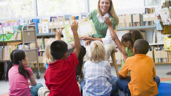 Woman reading to group of children