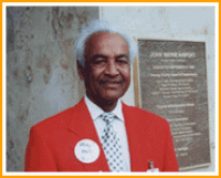 Man wearing a red suit posing for a photo